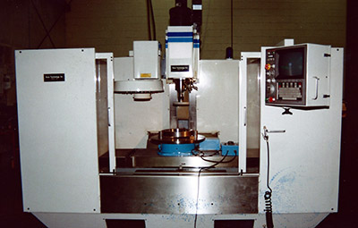 A rotary grinding table performing outside diameter milling work on a CNC machine